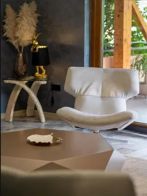 a white chair in a living room with a table at Villa Sun Castle in Kotor
