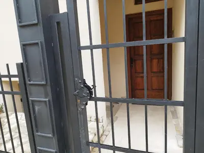 an open door of a building with a gate at DC Apartment D in Kotor