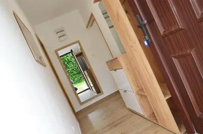 a room with a door and a mirror and a kitchen at DC Apartment C in Kotor