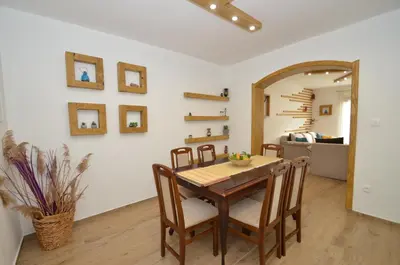 a dining room with a table and chairs at DC Apartment C in Kotor