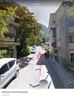 a street with cars parked on the side of the road at DC Apartment C in Kotor