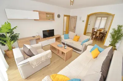 a living room with two couches and a tv at DC Apartment C in Kotor