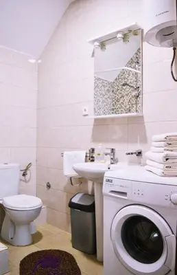 a bathroom with a washing machine and a sink at Apartments Nikčević in Budva