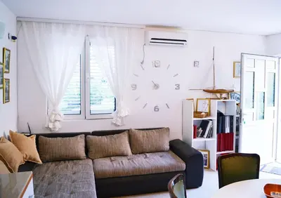 a living room with a couch and a window at Apartments Nikčević in Budva