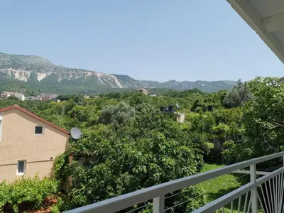 a view of the mountains from the balcony of a house at Apartments Nikčević in Budva