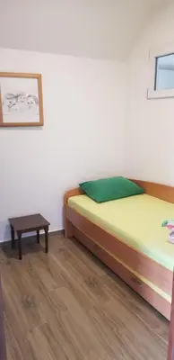 a bedroom with a bed and a table at Apartments Nikčević in Budva