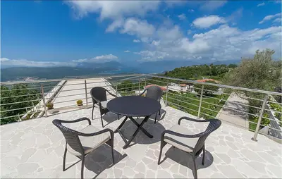 a patio with a table and chairs on a balcony at Nice Home In Kotor With Sauna in Kotor