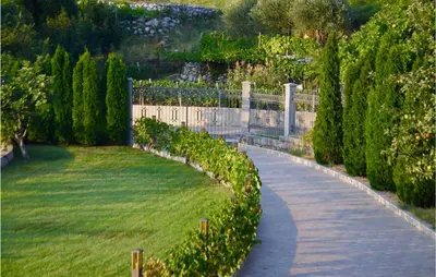 a path through a garden with trees and a fence at Nice Home In Kotor With Sauna in Kotor