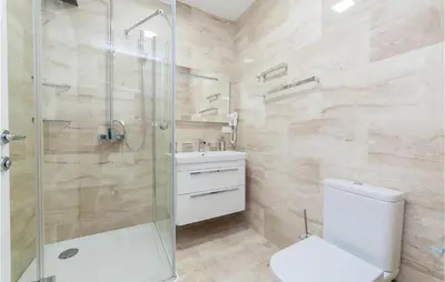 a bathroom with a shower and a toilet and a sink at Nice Home In Kotor With Sauna in Kotor