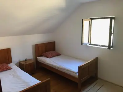 a bedroom with two beds and a window at Milovan in Cetinje