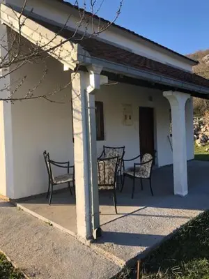 a porch of a house with two chairs at Milovan in Cetinje