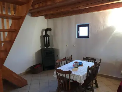 a dining room with a table and a stove at Milovan in Cetinje