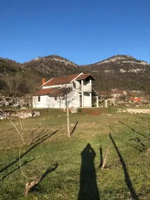a shadow of a person in front of a house at Milovan in Cetinje
