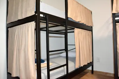 a black bunk bed in a room at Montenegro Backpackers Home Kotor in Kotor