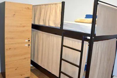 a room with two bunk beds and a ladder at Montenegro Backpackers Home Kotor in Kotor