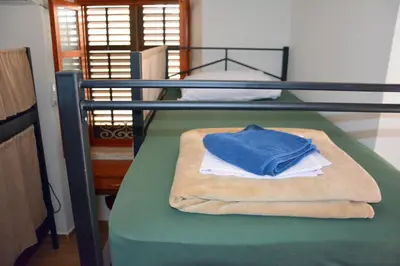 a bunk bed with a blue towel on top of it at Montenegro Backpackers Home Kotor in Kotor