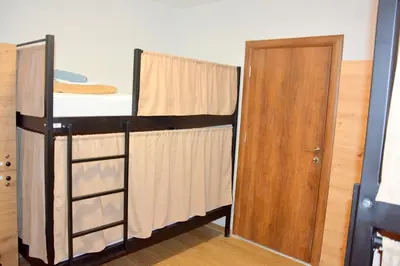 a small room with a bunk bed and a door at Montenegro Backpackers Home Kotor in Kotor