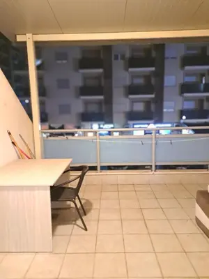 an empty room with a table and a bench at Apartment Bono 2 City Kvart in Podgorica