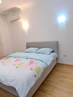 a bedroom with a bed with a colorful comforter at Apartment Bono 2 City Kvart in Podgorica