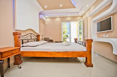 a bedroom with a bed and a tv and a window at Apartments Bella Vista in Kotor