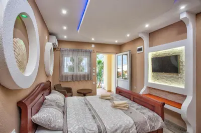 a bedroom with a large bed and a tv at Apartments Bella Vista in Kotor