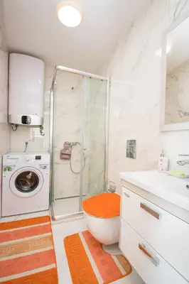 a bathroom with a shower and a washing machine at Celebrity Style Lux Apartment in Bar