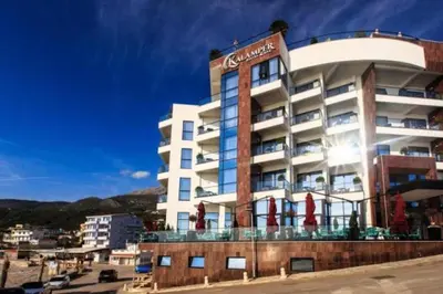 a large building with red umbrellas in front of it at Celebrity Style Lux Apartment in Bar