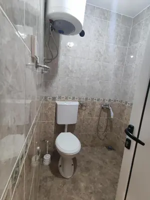 a bathroom with a toilet and a shower at Apartmani Vuković in Sutomore