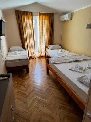 a room with two beds and a window at Guesthouse Vila Tamburic in Becici