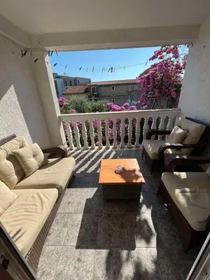 a living room with a couch and a coffee table at Guesthouse Vila Tamburic in Becici