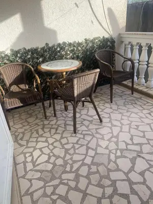 a patio with two chairs and a table and two chairs at Guesthouse Vila Tamburic in Becici