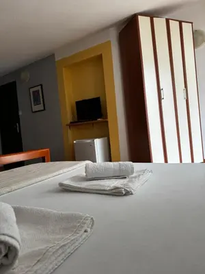 two towels sitting on a bed in a room at Guesthouse Vila Tamburic in Becici