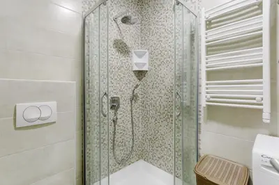 a shower with a glass door in a bathroom at Apartments LORA 13.Jula, 15 in Budva