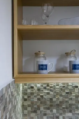 a wooden shelf with jars and glasses on it at P.S. Cattaro Apartments in Kotor
