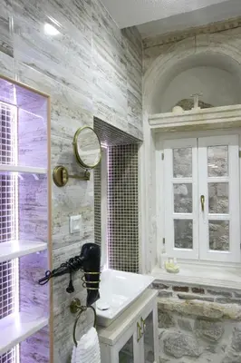 a bathroom with a sink and a mirror at P.S. Cattaro Apartments in Kotor