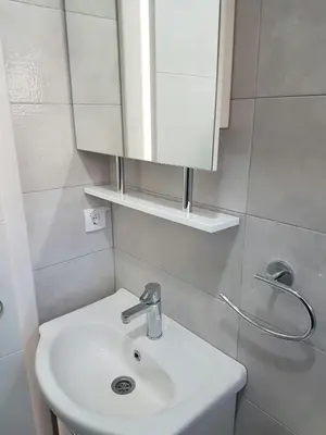 a bathroom with a white sink and a mirror at Porto Njeguši A1 in Cetinje