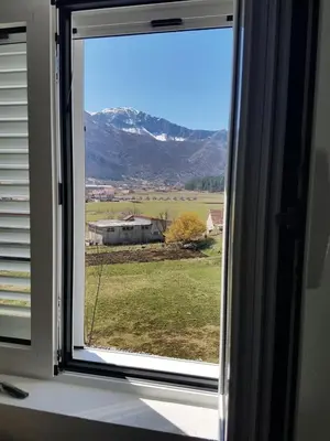 a window with a view of a mountain at Porto Njeguši A1 in Cetinje