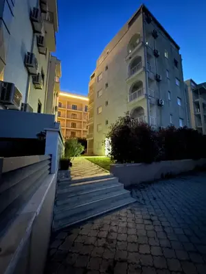 a building with stairs in front of a building at Long Beach Apartment in Ulcinj