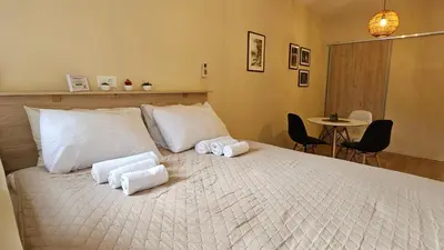 a bedroom with a bed with towels on it at Cicki Apartments I - Renovated 2025 in Podgorica