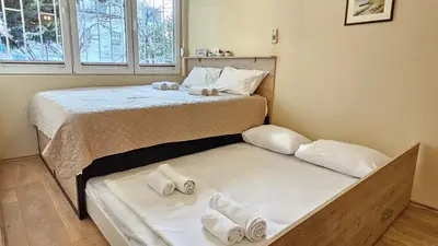 a bedroom with two beds with towels on them at Cicki Apartments I - Renovated 2025 in Podgorica