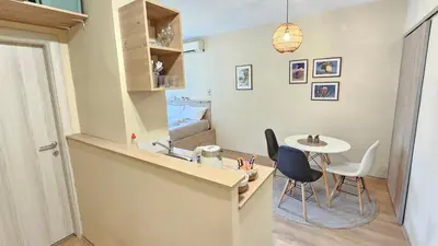 a kitchen with a table and chairs in a room at Cicki Apartments I - Renovated 2025 in Podgorica