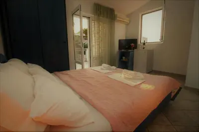 a bedroom with a bed with two towels on it at Apartments Mitrovići Miločer in Sveti Stefan