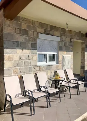 a group of chairs and a table on a patio at Albomi in Kotor