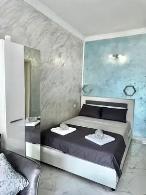 a bedroom with a bed with two towels on it at Albomi in Kotor