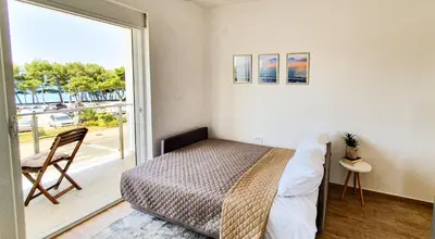 a bedroom with a bed and a large window at Olav Holiday Apartments Bar in Bar