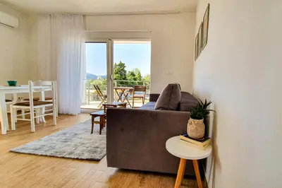 a living room with a couch and a table at Olav Holiday Apartments Bar in Bar