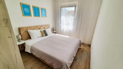 a bedroom with a bed and a window at Olav Holiday Apartments Bar in Bar
