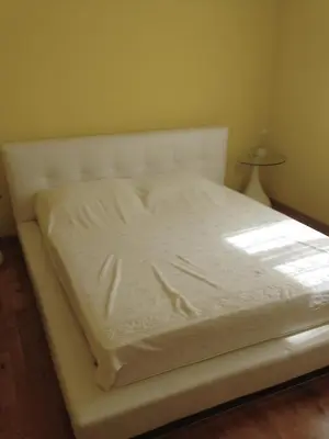 a white bed in a room with a lamp at BH Rialto in Sveti Stefan