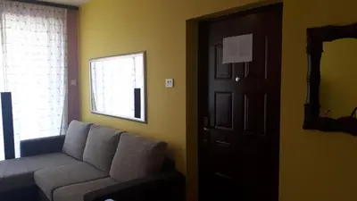 a living room with a couch and a door at BH Rialto in Sveti Stefan