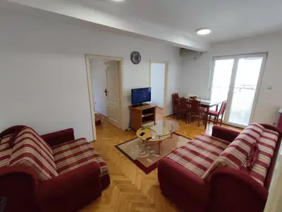 a living room with two couches and a table at Apartman Milica in Budva